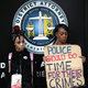 Black Lives Matter protesters hold a sign during a demonstration in front of the offices of Sacramento district attorney Anne Marie Schubert on April 4, 2018 in Sacramento, California.